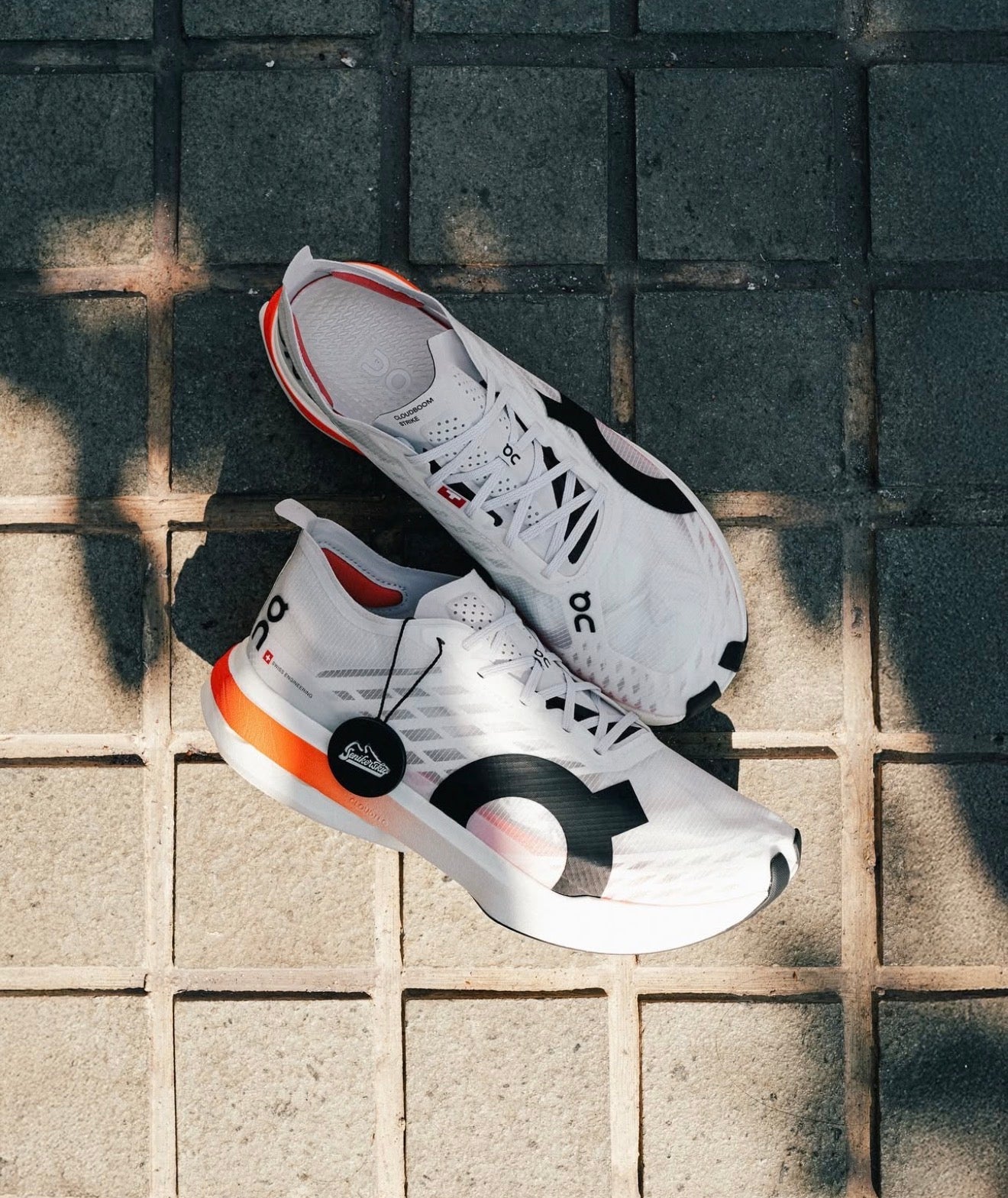 On Running Cloudboom Strike White Black Orange