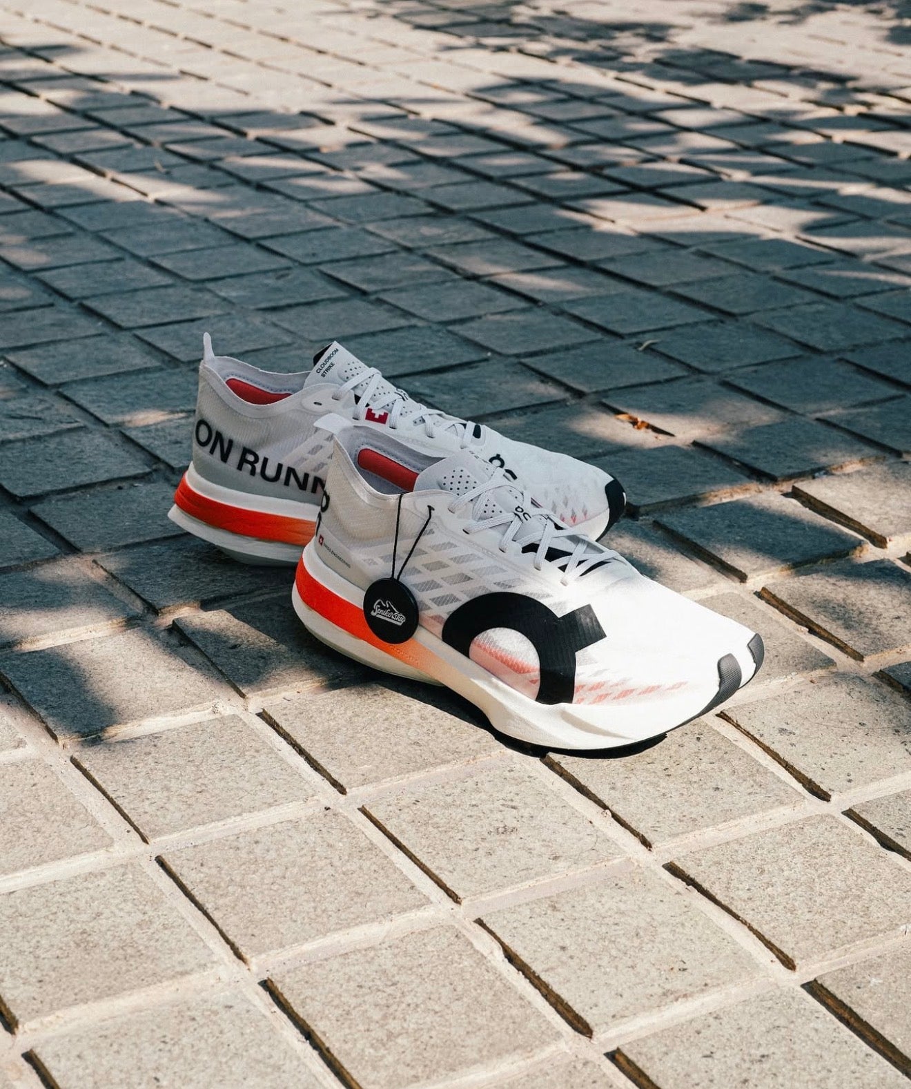 On Running Cloudboom Strike White Black Orange