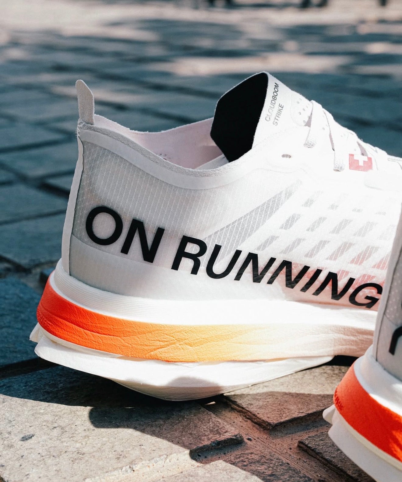 On Running Cloudboom Strike White Black Orange